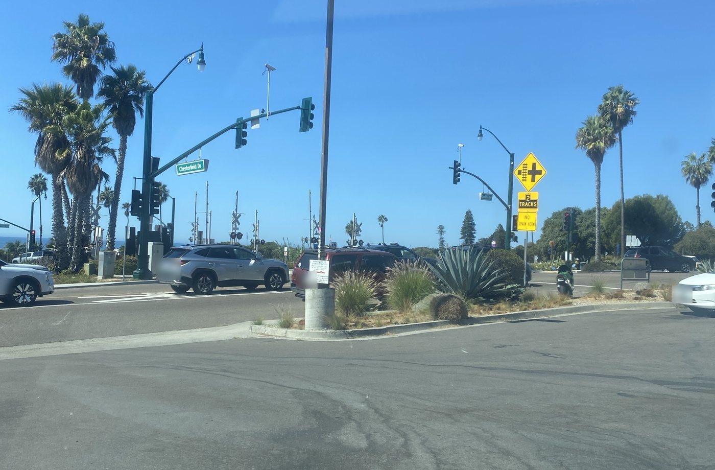 Chesterfield Dr at the railroad crossing in Cardiff, palms and a sliver of ocean beyond
