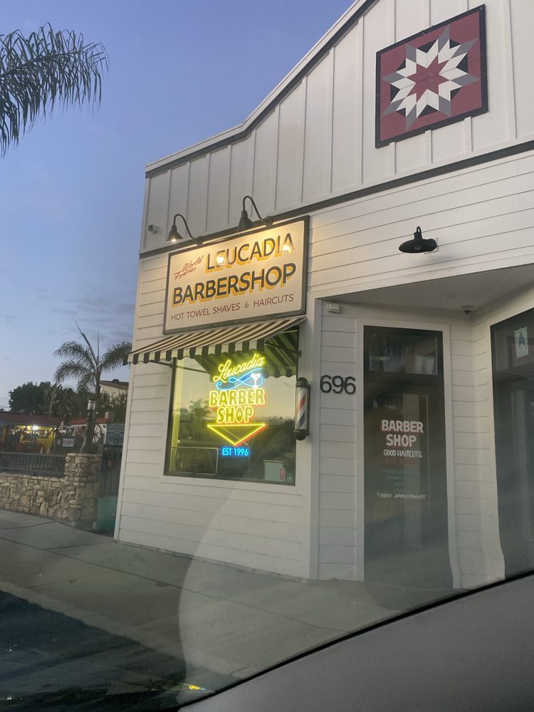 Leucadia Barbershop's lit sign and 'Est 1996' window neon