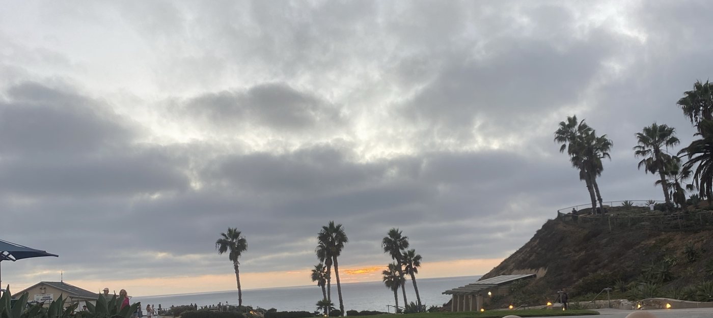 Clouds stacking up over the ocean at Fletcher Cove in Solana Beach at sunset, palms and the bluff, the night before Tropical Storm Rachel