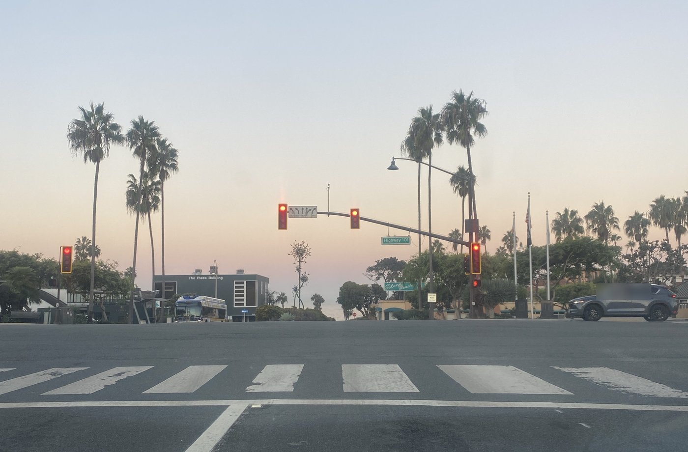 A red light on Highway 101 in Solana Beach at dawn, the ocean straight ahead