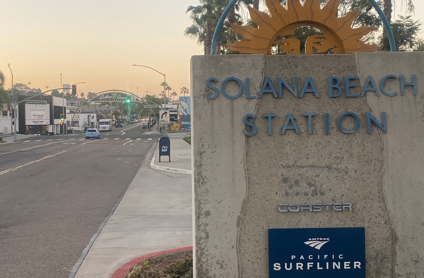 The Solana Beach Station sign with the Coaster and Amtrak Pacific Surfliner plaques at dawn