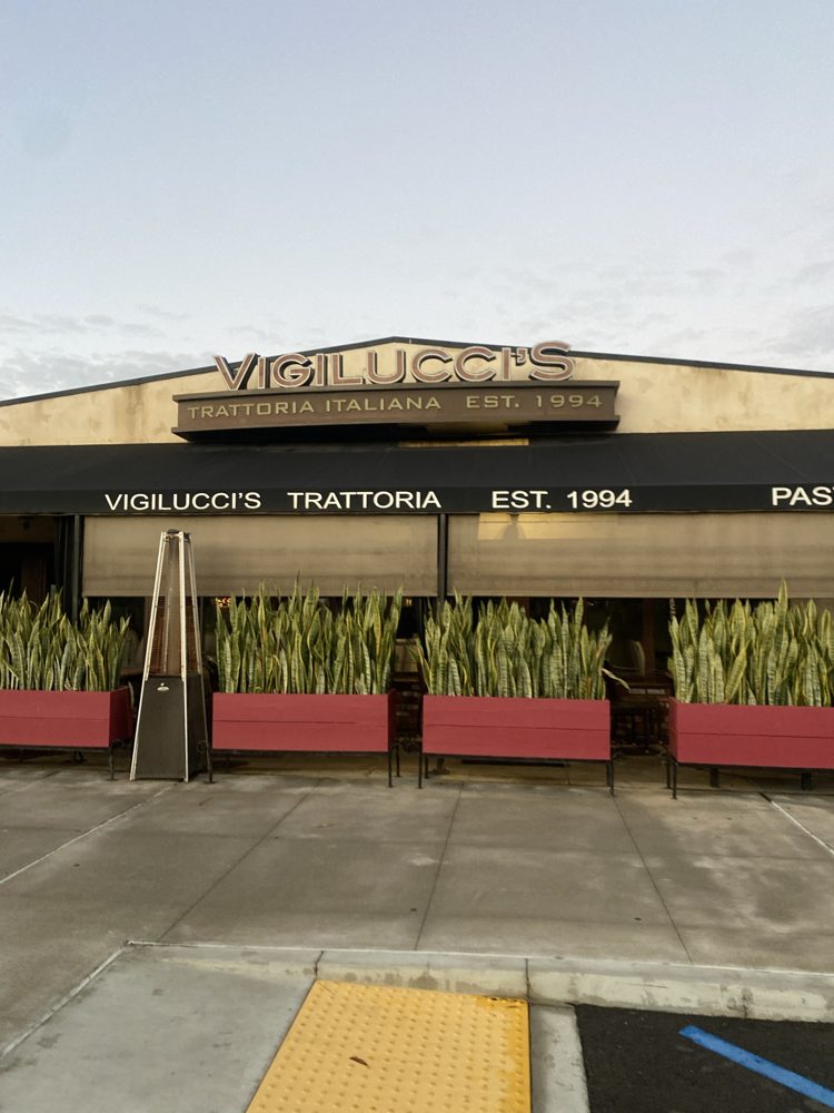 Vigilucci's 'Trattoria Italiana, Est. 1994' sign and black awning